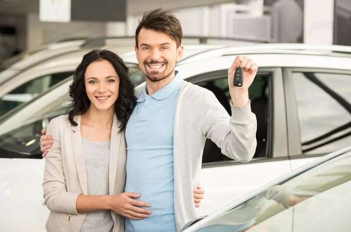 couple smiling and holding a car key | Performance Chrysler Jeep Dodge Ram Delaware in Delaware OH